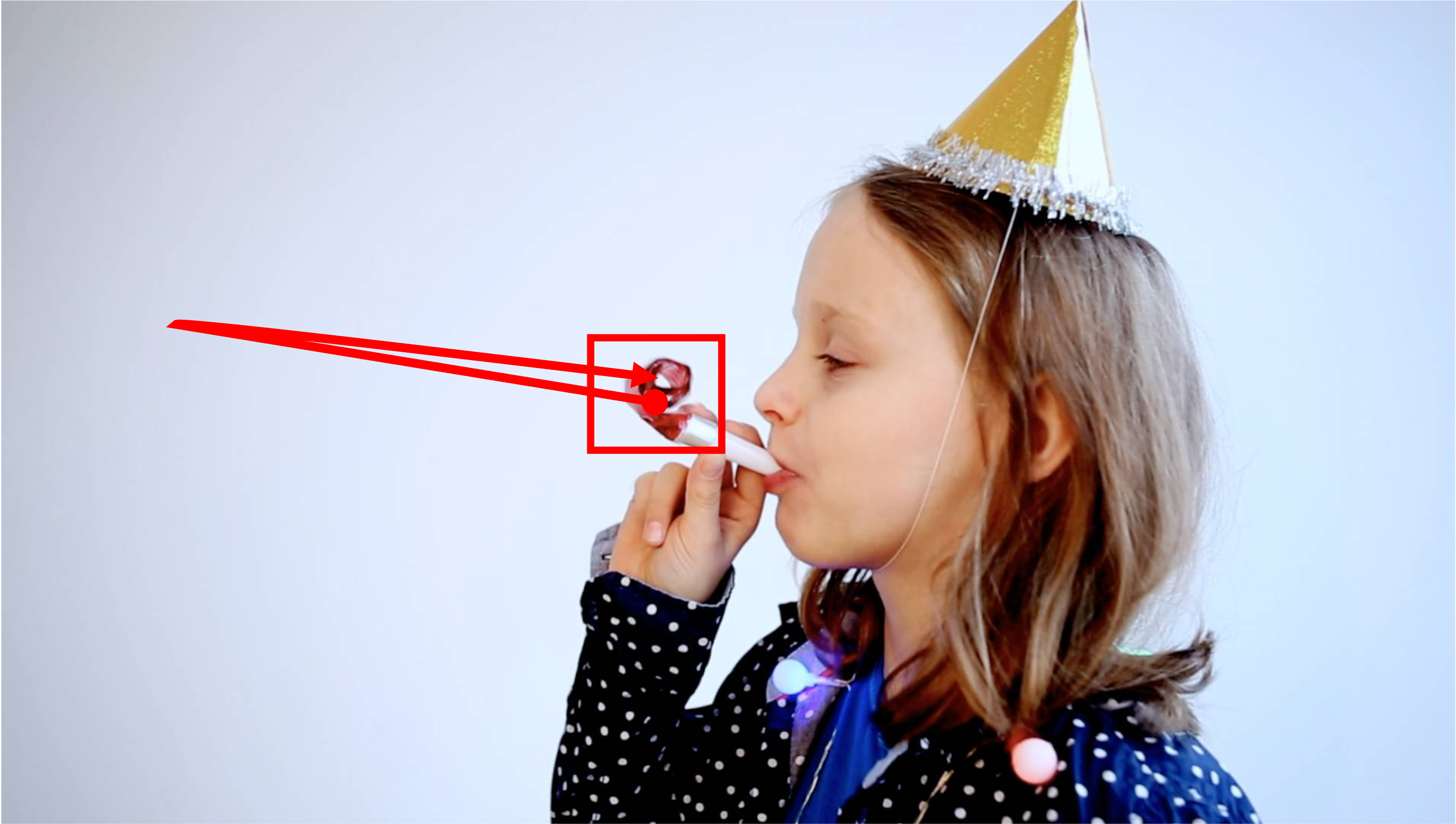An adorable baby girl on her birthday is holding a party blooper. The red part of the blooper shoots out and then retracts back while the white part remains still in place. Camera remains stationary. Static Camera. Camera locked down at the same place. The video loops back to the beginning of the video after it reaches the end.