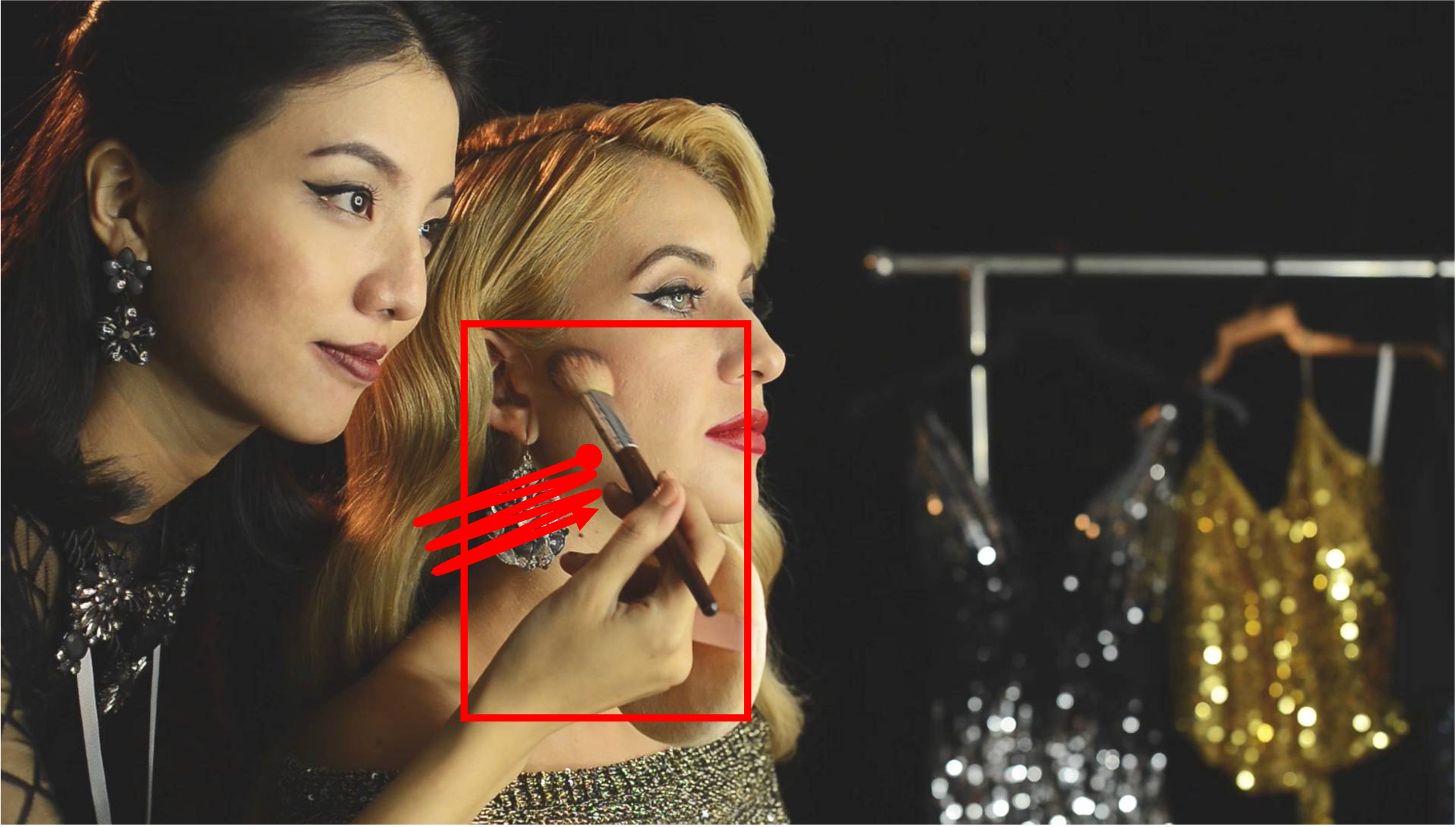 A makeup artist applying brush makeup to a celebrity. Both stay still in their posture, only moving the hand and the brush. Camera remains stationary. Static Camera. Camera locked down at the same place. The video loops back to the beginning of the video after it reaches the end.